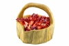 Red Christmas chocolates in a wooden basket on white background - A basket full of Christmas pralines